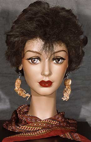PICTURE: colour police photograph of front view of mannequin head wearing human foetus earrings. A scarf covers the mannequin's neck