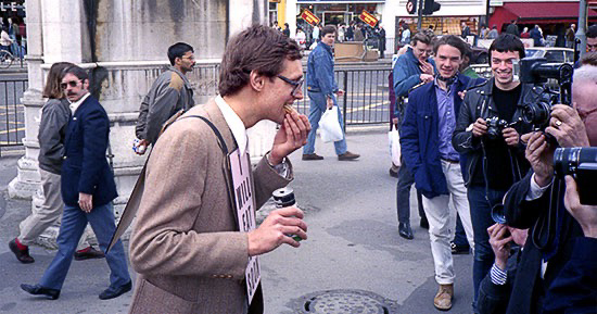 PICTURE: color photo of Gibson posing for photos with meat hors d'oeuvre in his mouth